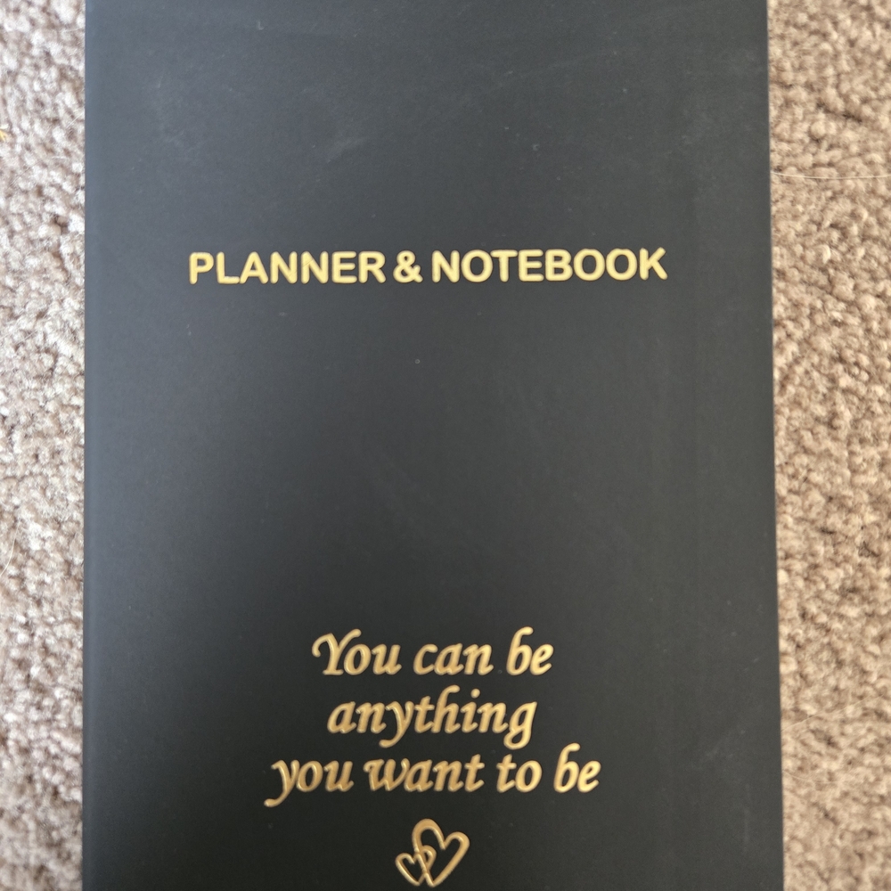 New in package-Stylish black/gold daily planner.